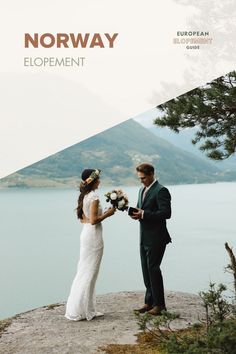 a man and woman standing next to each other on top of a cliff near the water