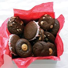 a box filled with chocolate covered cookies on top of a table