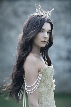 a woman with long hair wearing a tiara