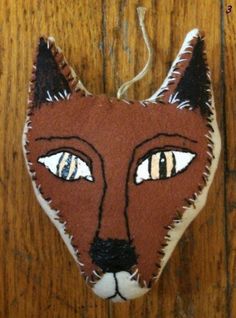 an ornament made to look like a fox's head on a wooden surface