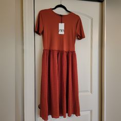 This Is A New Dress From Zara, Knee Length. It Could Fit Both Small And Medium Sizes. Stretch Pleated Short Sleeve Dresses, Pleated Stretch Dress With Short Sleeves, Stretch Pleated Dress With Short Sleeves, Casual Stretch Pleated Midi Dress, Casual Stretch Midi Dress With Pleats, Casual Stretch Pleated Dresses, Casual Pleated Orange Dress, Casual Orange Pleated Dress, Flowy Pleated Midi Dress With Short Sleeves