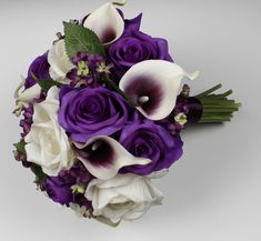 a bridal bouquet with purple and white flowers