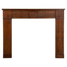 an antique wooden fireplace mantel with columns