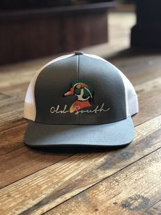 Keeping the hot southern sun out of your eyes and away from your face is important during the heat --both for guys and gals. The classic, wide-brimmed trucker subtly announces your southern roots. Stay in style with this Old South Wood Duck hat! Classic Adjustable Trucker Hat For Summer, Casual Curved Brim Snapback Hat For Country Events, Classic Snapback Summer Hats, Casual Flat Brim Hat, Pre-shrunk, Adjustable Brimmed Trucker Snapback Hat, Adjustable Trucker Sun Hat With Curved Brim, Classic Spring Trucker Hat With Curved Brim, Country Style Adjustable Trucker Hat With Flat Bill, Adjustable Trucker Snapback Hat