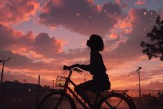 a person riding a bike at sunset with clouds in the background