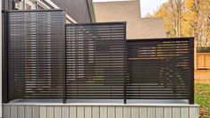 an outdoor privacy fence in front of a house