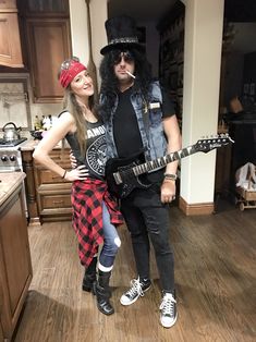 a man and woman dressed up as rock band members