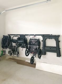 several wheelchairs are hanging on the wall in a room with white walls and flooring