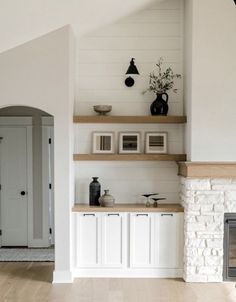 a living room filled with furniture and a fire place