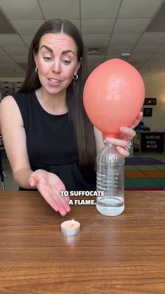 a woman sitting at a table with an object in front of her and the caption says, to suffocate a flame