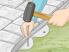 a person using a hammer to cut tile