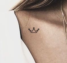 a woman with a small crown tattoo on her left side ribcage is shown