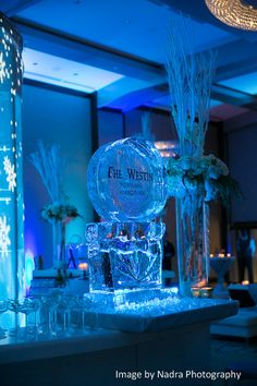 an ice sculpture is on display in the middle of a room with blue lights and snowflakes