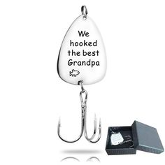 a fishing hook with the words we hooked the best grandpa on it next to a box