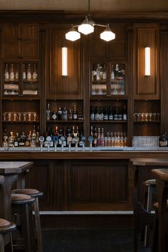 an empty bar with lots of bottles on the shelves