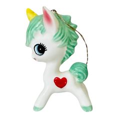 a white and green pony ornament with a heart on it's tail