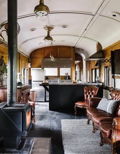 the interior of a train car with leather furniture