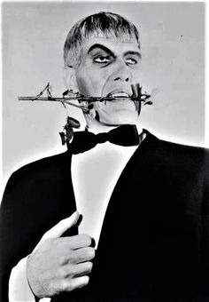 a man in a tuxedo with barbed around his mouth