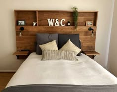 the headboard is made out of wood and has letters on it