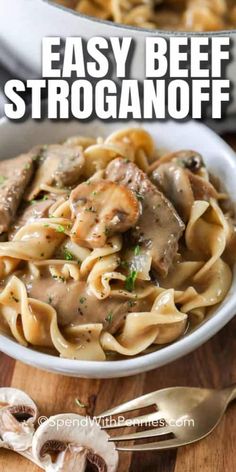 beef stroganoni with mushrooms in a white bowl on top of a wooden table