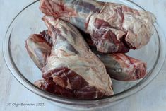 several pieces of raw meat in a glass bowl