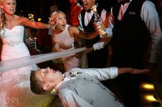 the bride and groom are dancing with their friends