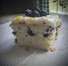 a piece of cake on a plate with blueberries