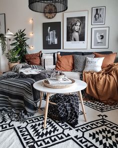 a living room filled with lots of furniture and pictures on the wall above it's coffee table