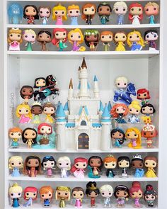 a book shelf filled with lots of disney princess figurines on top of each other