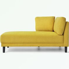 a yellow couch sitting on top of a white floor