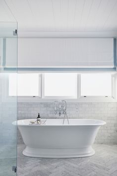 a white bath tub sitting next to a window