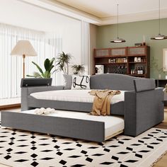 a living room filled with furniture and a rug on top of a hard wood floor