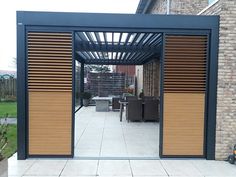 an outdoor patio with wooden slats and sliding doors