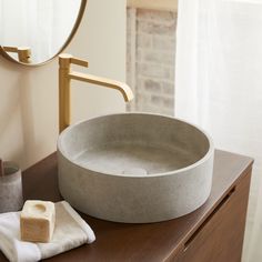 a bathroom sink sitting on top of a wooden counter