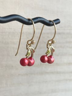 These dainty and cute cherry earrings are made of the following: (1) Gold plated red and green enamel cherry charm (12 x 10mm) (2) Gold plated or 14KGF earring hooks ✏️ Please choose your desired earring hooks 🍒EARRINGS 🍒 Clip On Hoops → https://www.etsy.com/listing/905698702 Threader -> https://www.etsy.com/listing/602107194 🍒NECKLACE 🍒 -> https://www.etsy.com/listing/615948435 【ADDITIONAL QUANTITY】 Kindly convo us if you require additional quantity and we will be happy to customize t Whimsical Red Drop Earrings, Cute Round Red Jewelry, Cute Red Round Jewelry, Cherry Colored Round Earrings For Gift, Cherry Round Earrings For Gift, Cute Red Dangle Jewelry, Cherry Colored Earrings For Valentine's Day Gift, Cherry Color Earrings For Valentine's Day Gift, Red Whimsical Nickel-free Earrings