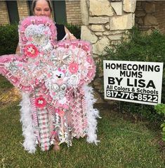 a woman standing next to a pink and white decoration