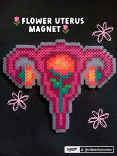 an elephant made out of perler beads with flowers on it's back and the words flower uterus magnet written below