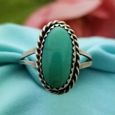 NATIVE AMERICAN Sterling Silver Oval Turquoise Split Ring-Beautifully Crafted.  Made in the 1960s.  This Bohemian Style Ring features a Large, Natural Turquoise Stone that is Half Bezel Set in a Solid and Stamped Sterling Silver Ring with a Unique Twisted Rope Border Design.  The Turquoise measures 13mm in Length The Ring Itself measures 11/16'' in Length x 7/16'' Wide Split Shank Size US 7 Weighs 2.70 Grams Vintage Turquoise Oval Cabochon Ring, Bohemian Oval Turquoise Collectible Ring, Vintage Oval Cabochon Turquoise Ring, Vintage Oval Turquoise Cabochon Ring, Southwestern Green Oval Turquoise Ring, Vintage Green Turquoise Oval Cabochon Ring, Western Style Untreated Oval Turquoise Ring, Adjustable Oval Turquoise Western Ring, Adjustable Oval Western Style Turquoise Ring