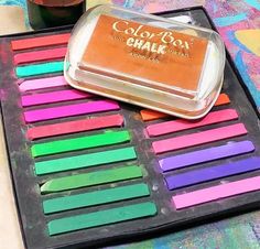 a tray that has some colored chalks on it