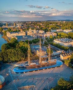 an aerial view of a large ship in the middle of a city with lots of trees