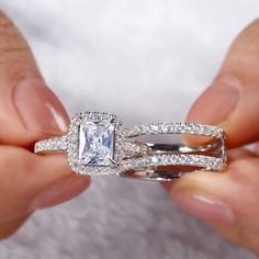 a person holding two wedding rings with an engagement ring on one hand and a diamond band on the other