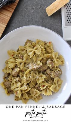 a white plate topped with pasta and meat