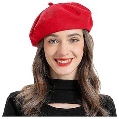 a woman wearing a red beret smiling at the camera