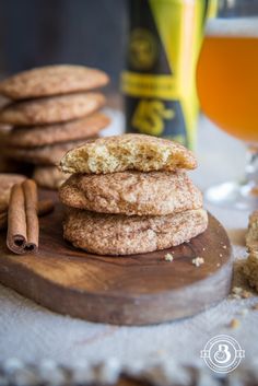 cookies stacked on top of each other next to cinnamon sticks and a glass of beer