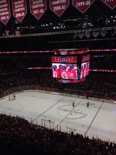 an ice hockey stadium with fans watching the game on large screen televisions in the stands