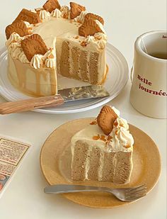 a piece of cake sitting on top of a plate next to a cup of coffee