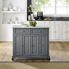 a kitchen island cart with two drawers on wheels