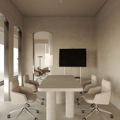 an empty conference room with white chairs and a flat screen tv mounted on the wall