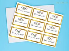 six olympic stickers with gold foil on them and the words you've got to see