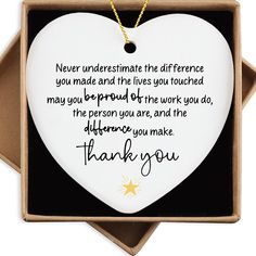 a white heart shaped ornament with a thank message